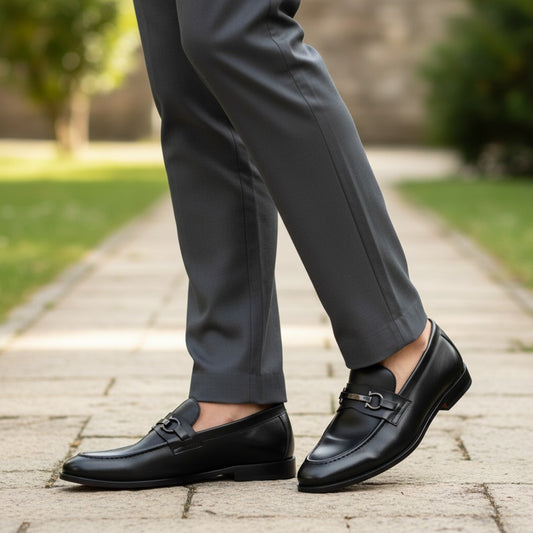 Aryaki black leather slip-on loafers with double G buckle detail. Classic dress shoes for men.