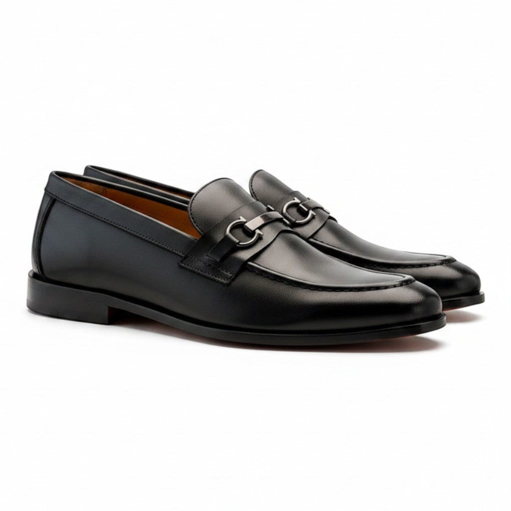 Aryaki black leather slip-on loafers with silver hardware detail. Classic dress shoes for men.