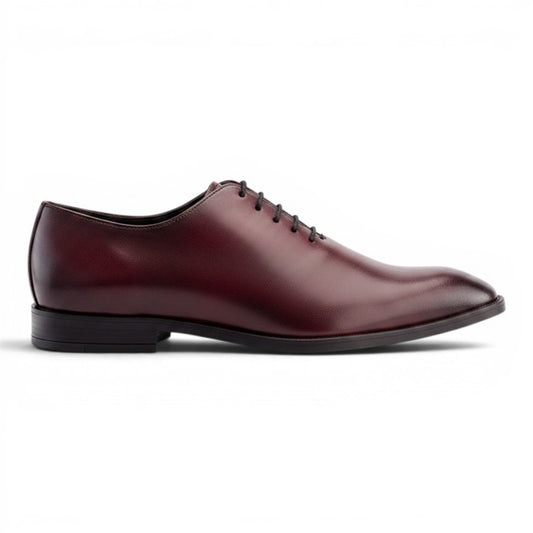 Aryaki Wholecut Oxford plain toe dress shoe in burgundy leather with black laces and a low heel.